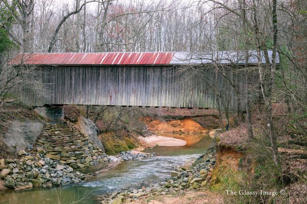 Side view of the covered bridge over stream