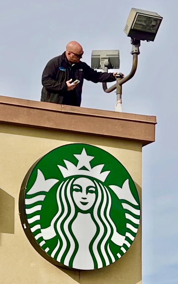 Certified commercial building inspector in Norman, Oklahoma on roof of Starbucks