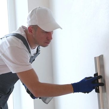 noble drywall finisher spackling a wall in bergen county drywall contractor near me