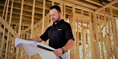 A noble drywall salesman representative looking at plans for a take-off