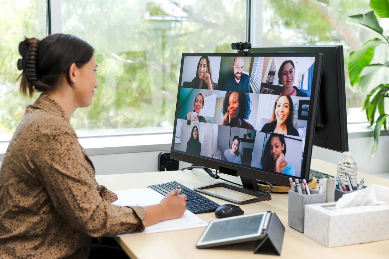 Woman participating in a video conference call at her desk.
