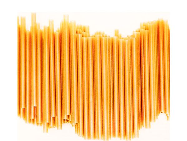 Close-up of uncooked spaghetti pasta arranged vertically.