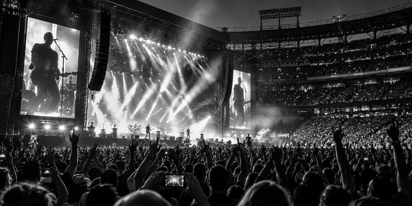 Concert crowd enjoying a live performance at a stadium.