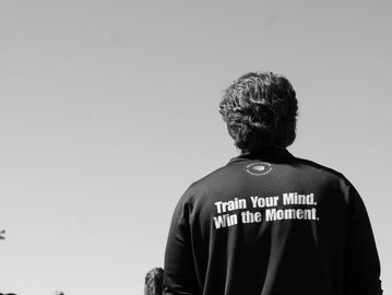 Person wearing a jacket with motivational text on the back.