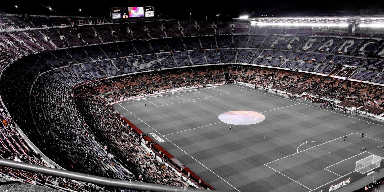 A large football stadium with some spectators.