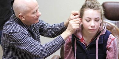 Ben Koperski Audiologist CCC-A, FAAA, fits a patient with digital hearing aids at Big Horn Basin Hea