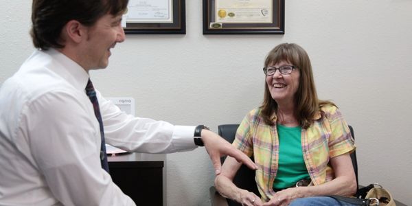 Dr. Levi Asay Au.D. listens to a patients concerns about her hearing at Big Horn Basin Hearing and S