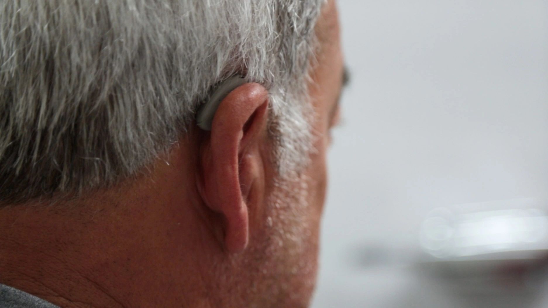 A patient wearing a discreet hearing aid.