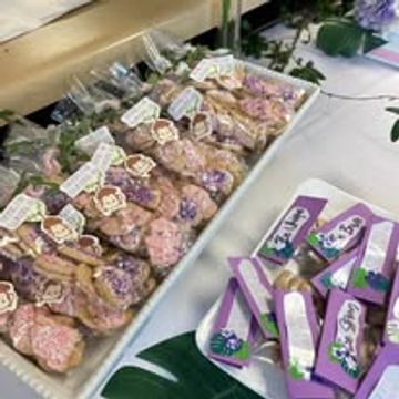Decorative cookies and purple party favors arranged on a table.