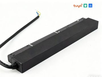 Black rectangular electronic device with cable, branded Tuya.