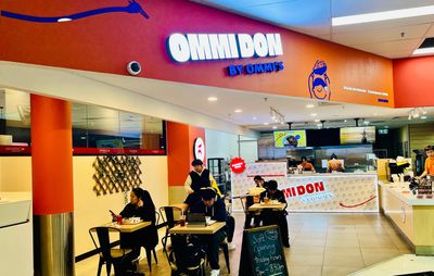 Interior of Ommi Don restaurant with customers dining and staff working.