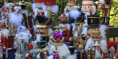 Collection of colorful nutcrackers displayed outdoors.
