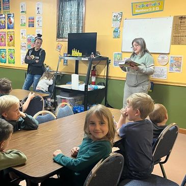 Teacher reading to children in a classroom setting.
