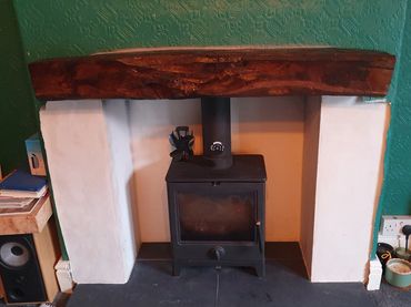 Repurposed oak lintel over log burner