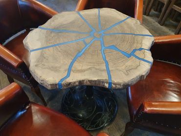 Walnut disc and blue epoxy resin table on black cast iron leg