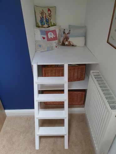 Child's reading nook with shelves and ladder