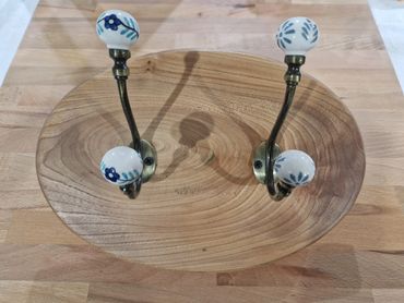 Coat hooks on an elm oval