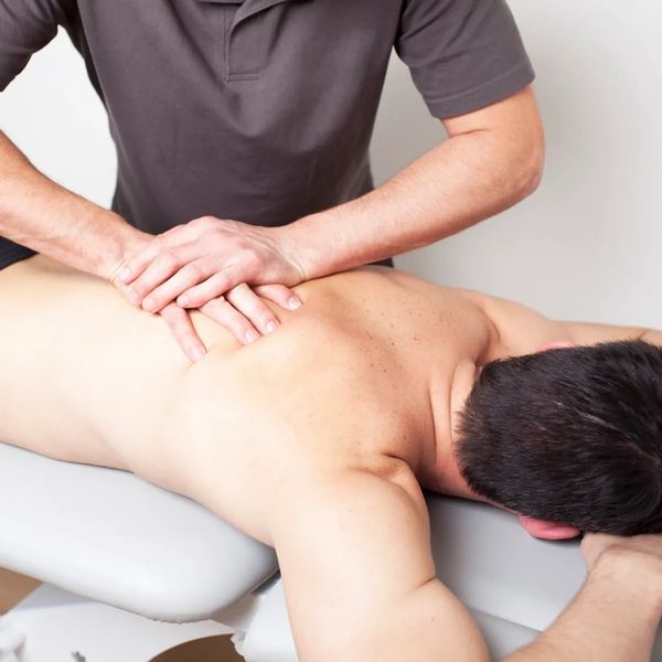 Massage therapist performing myofascial massage on a client 
