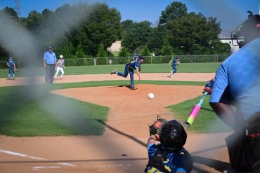Youth baseball game with a pitcher and batter.