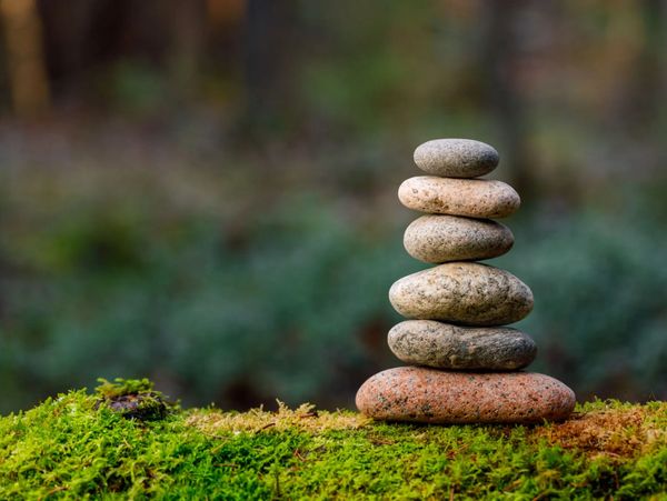 Stacked stones in nature symbolizing balance and harmony with Acupuncture. 
 Kiran Schaffer Register