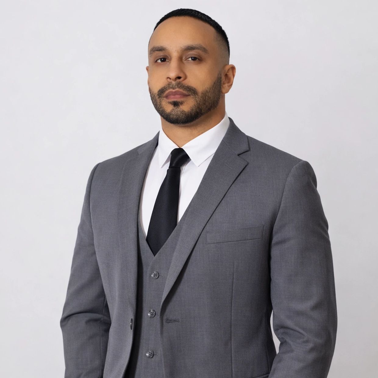 Man in a gray suit and black tie.