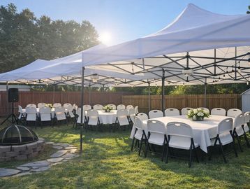 Outdoor event setup with white tents and round tables with chairs.