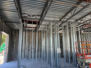 Interior view of a building under construction with metal framing.