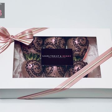 Dark chocolate covered strawberries with pink luster dust and hand piped chocolate designs 