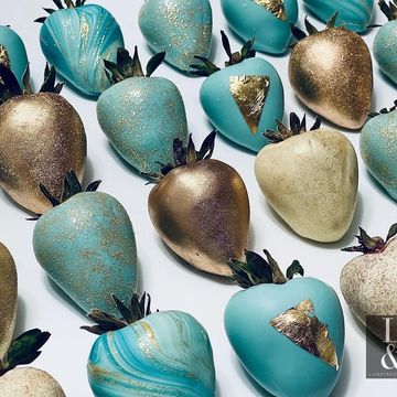 aqua blue chocolate covered strawberries in white chocolate, gold luster dust, gold leaf, and marble