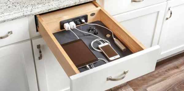 a tablet, mobile phone, and chargers in a drawer 