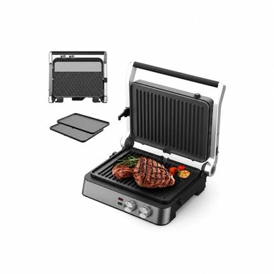 Electric grill with steak and vegetables.