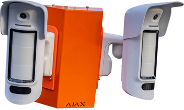 Two white Ajax motion detectors mounted on an orange box.