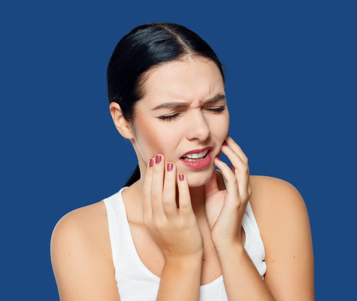 Woman in pain holding her jaw, indicating a toothache.