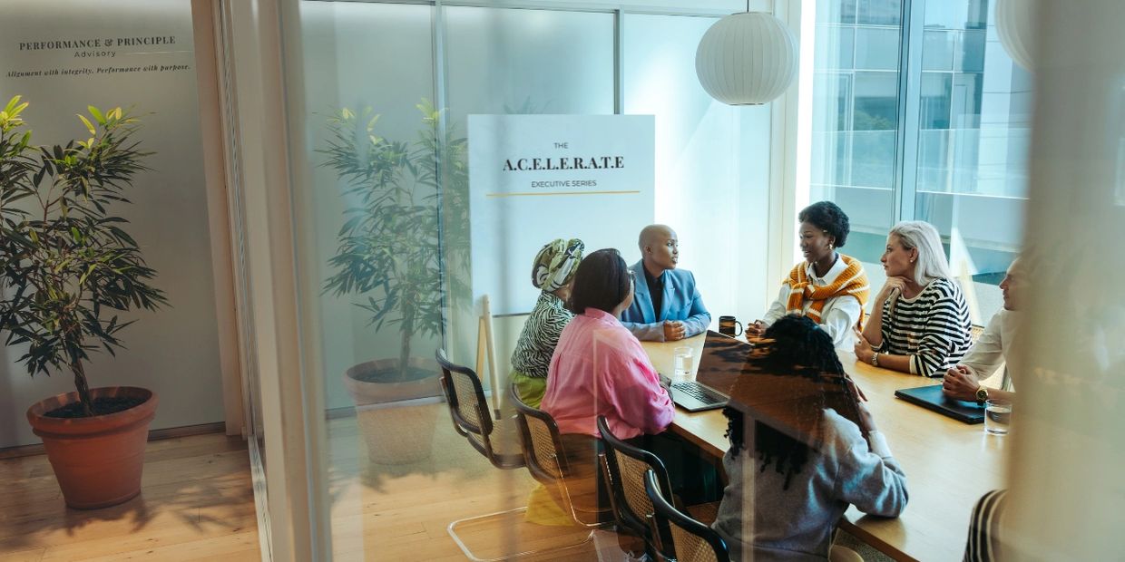 Professionals meeting in a conference room at Performance & Principle Advisory office.