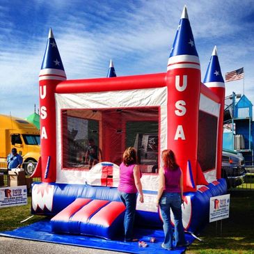 Red, white, and blue patriotic USA rocket inflatable bounce house