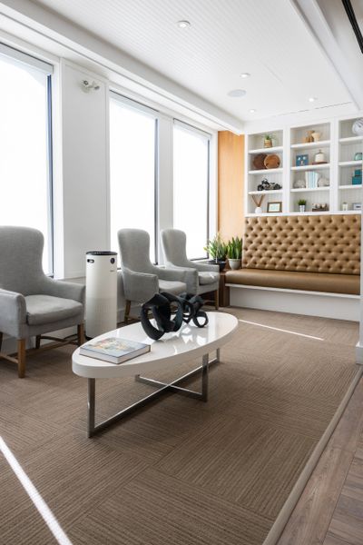 Bright, modern waiting area with comfy chairs and a stylish coffee table.