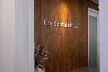 Wood-paneled wall with a sign reading 'the dental clinic.'