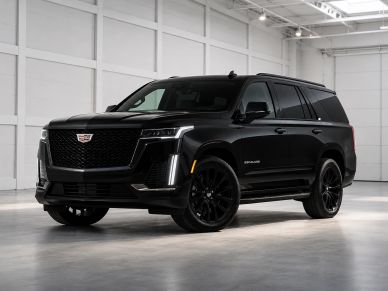 Black Cadillac Escalade SUV in a showroom.