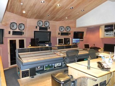 Where gleaming mixing boards meet walls humming with sonic alchemy. 