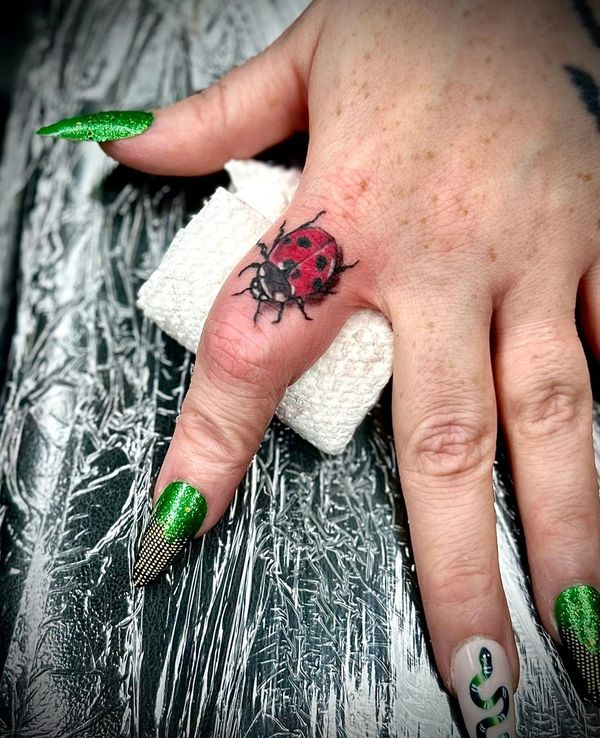 Micro tattoo finger tattoo. Lady bug tattoo realistic full color. Charlotte nc. Walk in tattoo