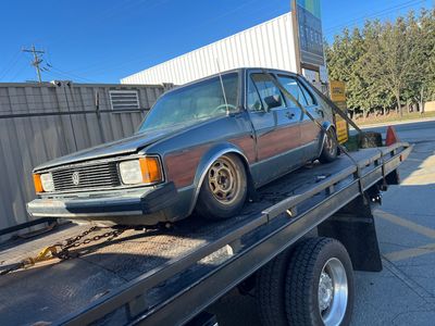 Older Volkswagen on a flat deck for Vancouver junk car removal and local pickup.