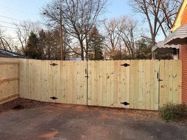 Newly installed wooden fence gate in a residential backyard.