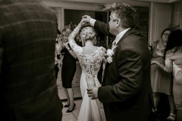 a black & white image of Bride leading groom to the dance floor at Friern manor 