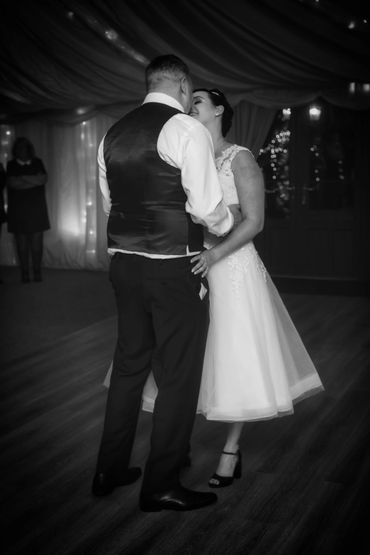 Bride and groom nose to nose whilst celebrating their first dance at Newlands Hall 