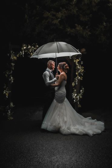Elegant wedding portrait under an umbrella at Stock Brook Manor, Essex. 