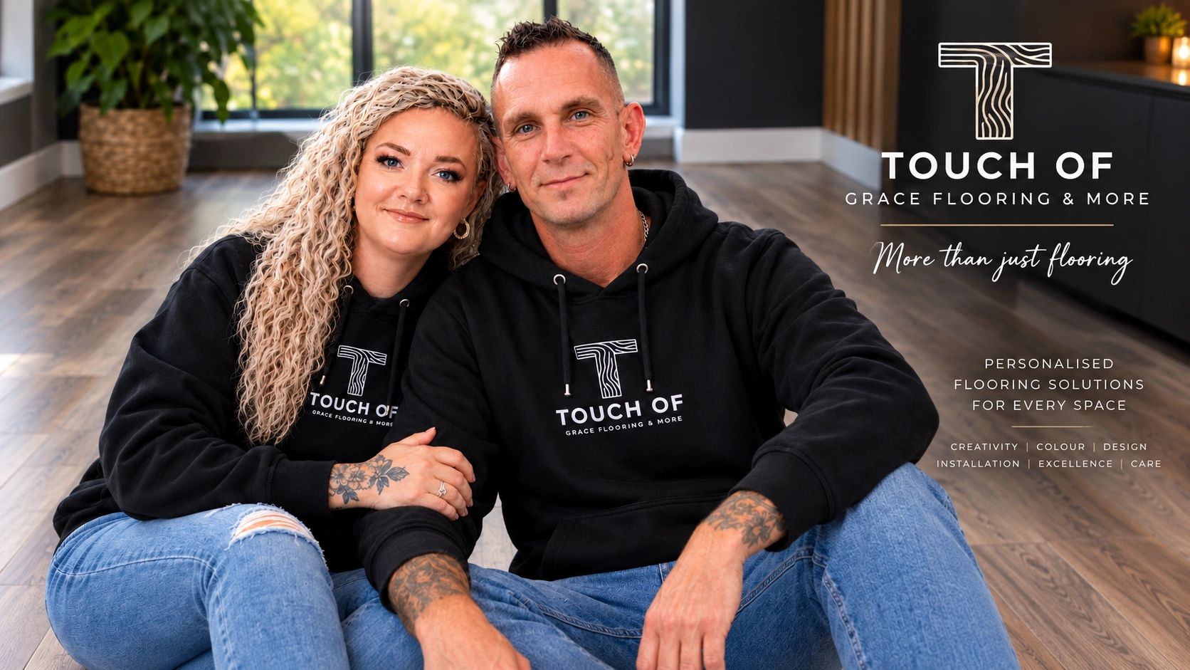 Couple in branded hoodies promoting personalized flooring solutions.