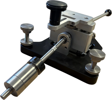 Precision mechanical tool with adjustable knobs and levers on a black base.