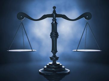 A black balance scale symbolizing justice and fairness.