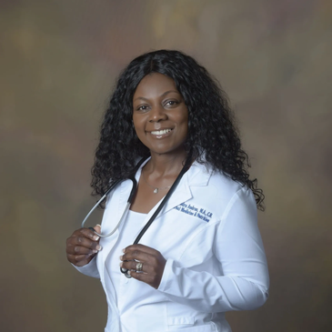 Confident female doctor in white coat with stethoscope smiling.