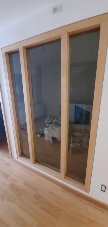 Wood-framed glass windows in a room.